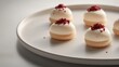 © Rizvan - Elegant wedding canapÃ©s featuring delicate macaron desserts with cream topping and garnished with red sprinkles on a minimalist plate.