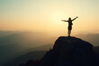 © Tatyana - Triumphant Woman Silhouette Celebrating Achievement Against Majestic Mountain Sunset