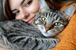 © CRISPIFLY - Girl cuddling tabby cat close up portrait pet love friendship affection animals mammals domestic