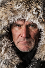 portrait of a man in fur cloak amid snowy landscape