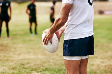 Poster - Man, hands and rugby ball for game, outdoor and challenge with exercise, wellness and fitness. Male person, athlete and recreation facility as team for match, sports and training in stadium or arena