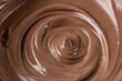 © BarTa - Mocha chocolate mousse, cocoa milk cream spiral texture as background. Trendy color of 2025 year Mocha Mousse.