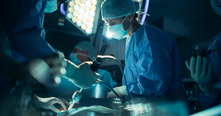 Poster - Portrait of a Female Surgeon Using Laparoscopy Instrument, Working on a Critical Operation in a Dark Room with a Team. Each Hospital Member Focusing on Their Role to Keep Patient Alive and Healthy