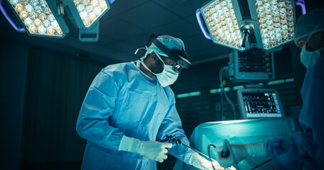 Poster - Lead Surgeon Navigating Complex Steps in Real-Time with the Help of an Augmented Reality Glasses. Black Male Medical Professional is Aided by Nurses and Surgical Assistants in a Coordinated Teamwork