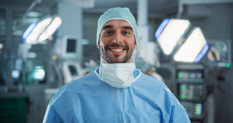 Poster - Portrait of a Caucasian Surgeon Taking off His Surgical Mask After a Successful Operation. Healthcare Professional Posing, Looking at Camera and Smiling. Photo in a Modern Hospital Operating Room
