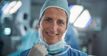 Poster - Portrait of a Caucasian Medical Professional, Nurse, Medical Assistant, Doctor or a Surgeon Taking off a Surgical Mask after Successful Surgery. Modern Hospital Operating Room in the Background