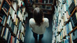 © DOUGLAS - woman stands in library surrounded by shelves of books, viewed from above, creating serene and contemplative atmosphere