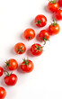© fotoluigi868 - Cherry tomatoes create a visually striking diagonal pattern against a minimalist white background ideal for creative food design use._00001_