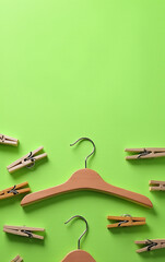Poster - Clothespins are attached to hangers and placed on a bright green colored background in an organized and visually appealing manner._00002_