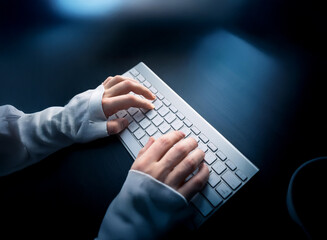 Poster - Close-up of hands typing on a white keyboard in a dimly lit room.  The scene evokes a sense of focus and digital work.