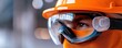 © Arnon  Parnnao - A focused construction worker wearing safety gear, including a helmet and goggles, ensuring safety on site.