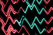 © wolfhound911 - A neon background featuring sharp zigzagging lines in electric red and teal, glowing against a deep black backdrop.