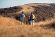 © Zoran Zeremski - Rear view two woman hiking at top of the hill at meadow.