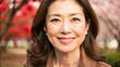 © Tatiana - Portrait of a middle-aged Japanese woman smiling in front of blooming trees