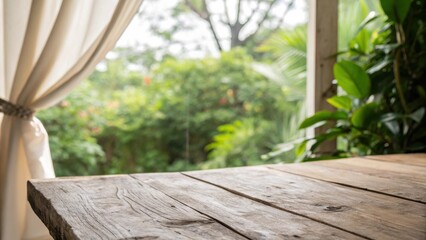 Poster - Close-up of a weathered wooden table with a blurred background of lush greenery and a white curtain