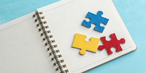 Poster - A blank lined notebook with puzzle pieces signifying a solution to a problem, creating a space for brainstorming and idea generation.