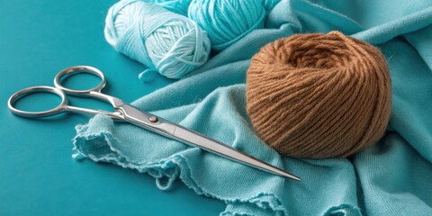 Poster - A close-up view of a pair of scissors, brown yarn, and turquoise yarn on a turquoise surface