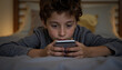 © Olga Ко - Boy Holding a Phone Lying on the Bed Lifestyle Photo Close Up
