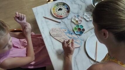 Wall Mural -  A young mother and her daughter enjoy a creative art session at home 