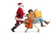 © Ljupco Smokovski - Santa Claus pushing a young african american man with shopping bags in a cart
