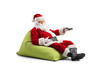 © Ljupco Smokovski - Santa Claus sitting in a beanbag and holding a remote control