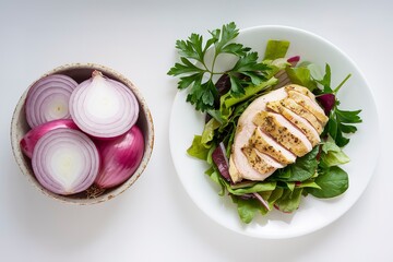 Wall Mural - a bowl containing thinly sliced onions, and a plate with a salad consisting of chicken breast