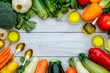 © Віталій Б. - Fresh vegetables and olive oil arranged artfully on wooden table for healthy cooking