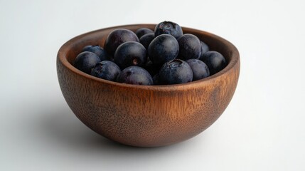 Aufkleber - Fresh blueberries artistically arranged in a rustic wooden bowl against a clean white backdrop showcasing their vibrant color and texture