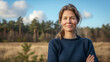 © tiagozr - Middle-aged woman smiling confidently in a natural outdoor setting.