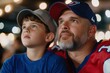 © Babb - A man and a boy are watching a sports game