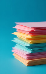 Poster - Note paper with vibrant colors is neatly stacked against a deep blue backdrop creating a visually appealing scene._00002_