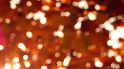 Wall Mural - video of autumn brown abstract blurred background with bokeh effect with hexagonal stars flashing on