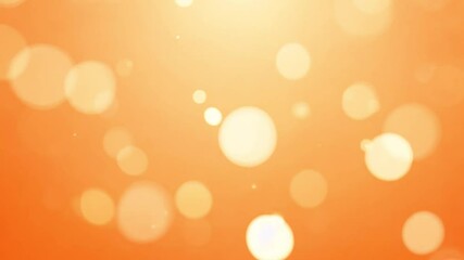 Zoom out video of a light orange background with shimmering bokeh lights and randomly scattered, small sparkles