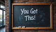 © Elenba - Chalkboard sign with motivational message 'You Got This!' in a cozy brick-walled environment