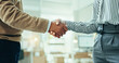 © peopleimages.com - Business people, handshake and meeting with teamwork for agreement, deal or partnership at office. Closeup, employees or colleagues shaking hands for negotiation, hiring or recruiting at workplace