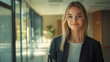 © Michael - Confident female executive standing in a modern office hallway exuding professionalism and success in her portrait