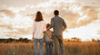 © kieferpix - Dad mom son child together, nature. Happy family, children  walking in park at sunset. Family, child, walk through summer field bonding