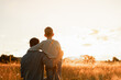 © kieferpix - Father hugging little child son and watching the sunset over the field together. Family parenting togetherness concept