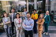 © Mediteraneo - Group of multiracial businesspeople on a seminar standing and looking at the camera.