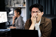 © Summit Art Creations - Working businessman feeling extremely sleepy with yawning while working on desk with unfinished project at workplace with coworker trading stock market investment at over late night time. Infobahn.