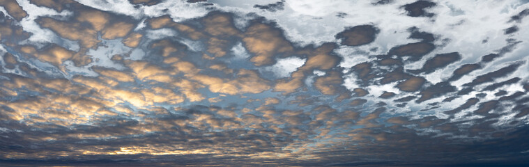 Wall Mural - panorama of a cloud filled late day sky with blue sky fading to transparent