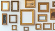 © Thiago - An assortment of ornately-framed, gilded picture frames adorn a white wall, each with a blank canvas ready to be filled with a work of art. Gilded. Illustration