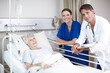 © peopleimages.com - Medical, team and patient portrait in hospital bed for healthcare results, surgery information or checkup. Senior woman, nurse or doctor with clipboard in clinic for health support and rehabilitation