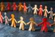 © Nedrofly - Colorful paper figures hold hands in a creative arrangement, symbolizing unity and teamwork