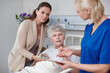 © peopleimages.com - Daughter, senior woman and nurse in clinic for treatment, diagnosis or results as cancer patient. Elderly person, family and healthcare services with medical examination, consultation or consent form