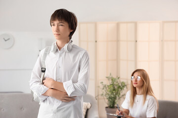 Wall Mural - Sad teenage boy at psychologist's office