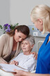 © peopleimages.com - Daughter, elderly woman and nurse in clinic for visit, diagnosis or results as cancer patient. Senior person, family and healthcare services in medical examination, consultation or doctor appointment