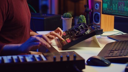 Poster - Audio engineer working with soundboard to create the perfect sounds for his new songs, recording and mixing audio. Music producer adjusts volume levels during recording sessions. Camera A.