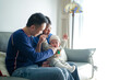 © Masakazu Tokashiki - A 6-month-old boy spends time on a couch with his mother and father from a Chinese family on a cold winter day in an apartment building in the Pudong New Area of ​​Shanghai, China.