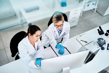 Poster - Above, science and women with pc, research and check results in laboratory. People, employees and coaching in workplace, computer and conversation with cure, online report and feedback for experiment